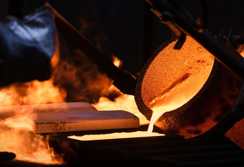 Gold hits over 2-week low on hawkish Fed bets, firmer dollar