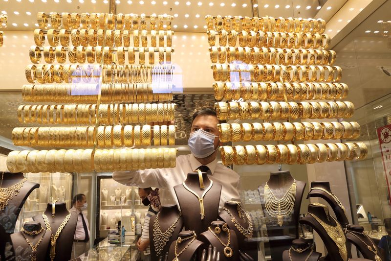 Gold set for fourth weekly loss on dollar strength, Fed hike bets