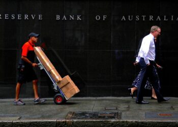 Australia’s central bank holds rates, warns of possible further hike