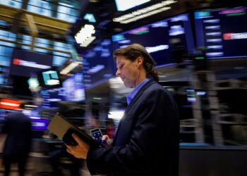 Dow closes at record high as tame inflation report also lifts small caps