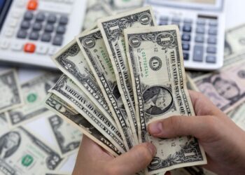 Dollar flat as market awaits tariff direction, central bank decisions