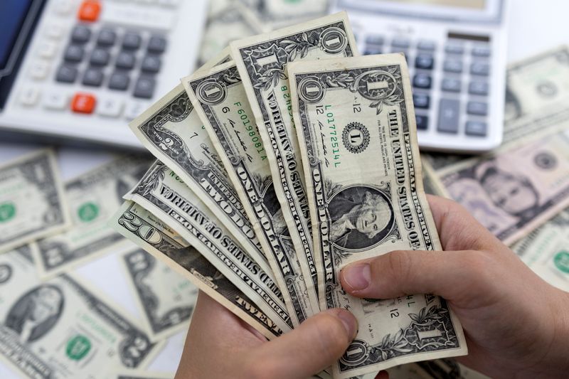 Dollar flat as market awaits tariff direction, central bank decisions