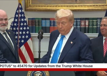 Standing just behind the president, MAGA Rep. Derrick Van Orden appeared to awkwardly mouth, “I’m here.”