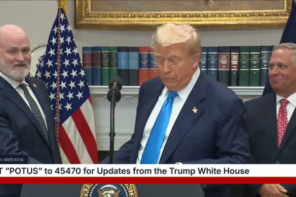Standing just behind the president, MAGA Rep. Derrick Van Orden appeared to awkwardly mouth, “I’m here.”