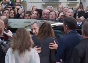 Former French president Nicolas Sarkozy greets supporters, hugs wife before heading to prison