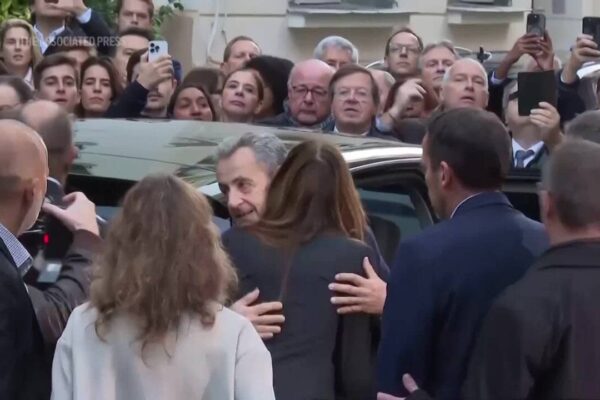Former French president Nicolas Sarkozy greets supporters, hugs wife before heading to prison