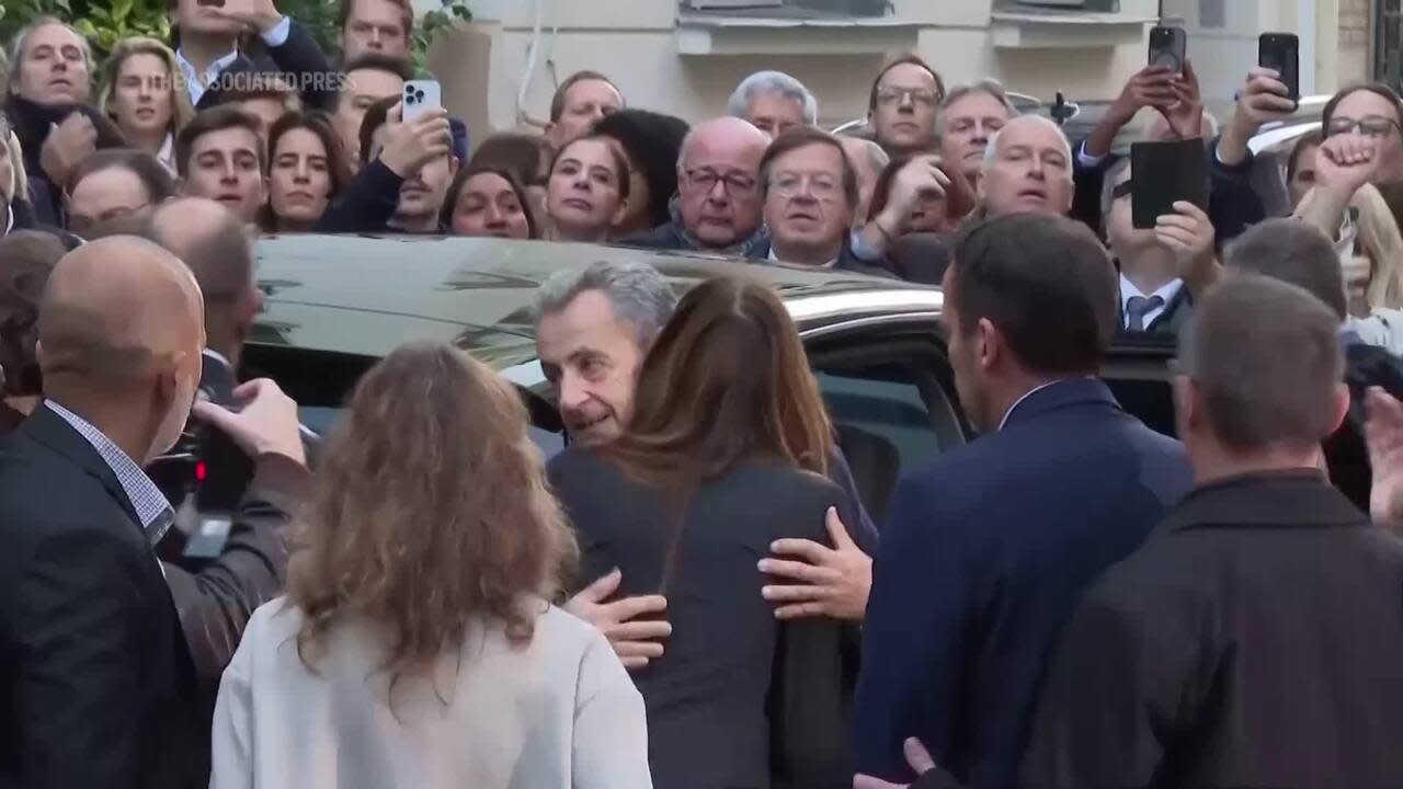 Former French president Nicolas Sarkozy greets supporters, hugs wife before heading to prison